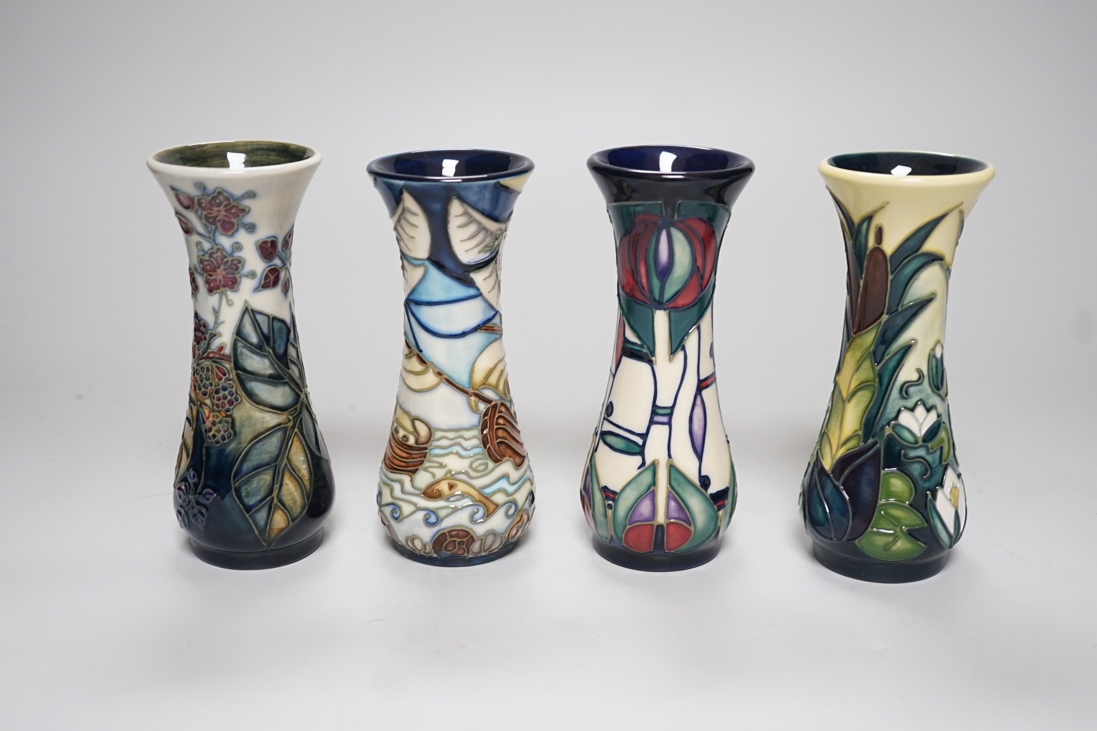 Four boxed small Moorcroft vases, Blackberry, Bulrush, Winds of Change, and a Rennie Macintosh Tribute. Each 11cm high